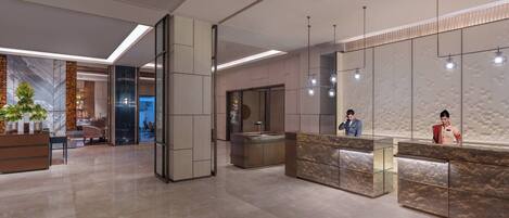 A modern hotel lobby with a reception desk, seating area, and a large mirror.