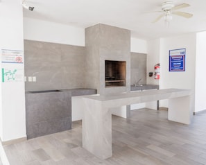 A modern kitchen with a built-in stove, a sink, and a ceiling fan.