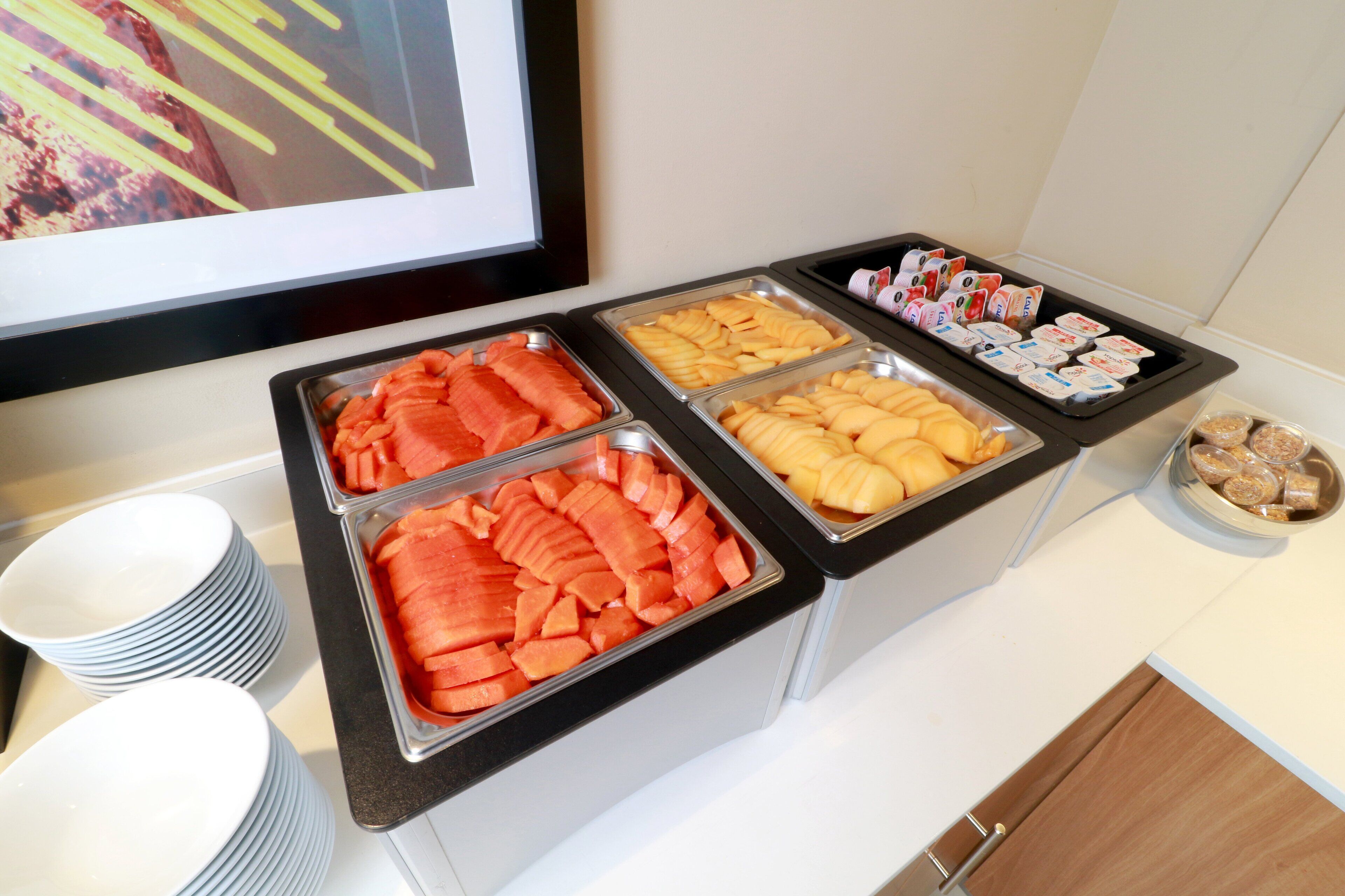 A buffet with various food items including fruits, vegetables, and dairy products.