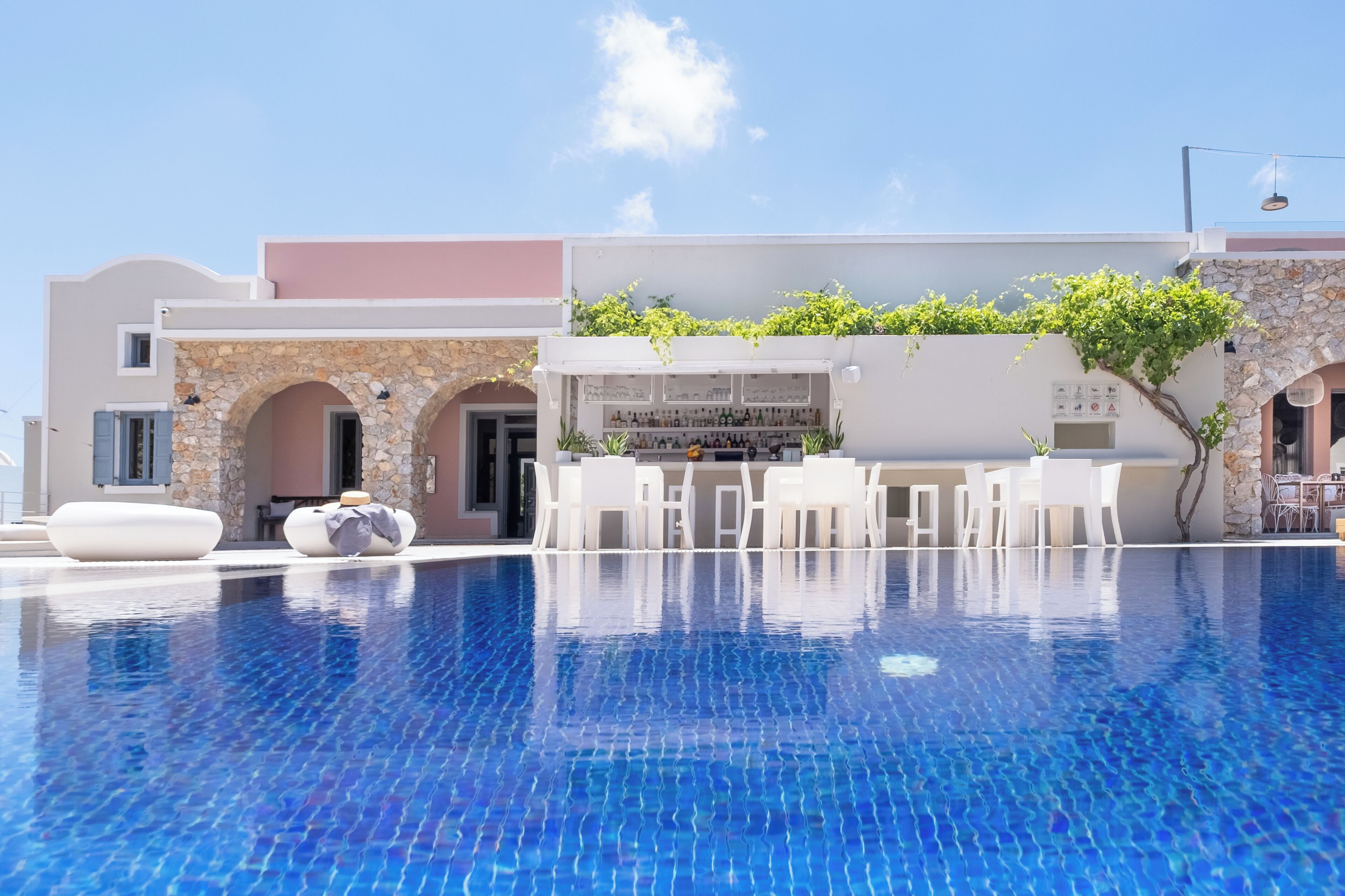 A poolside area with a bar and seating.