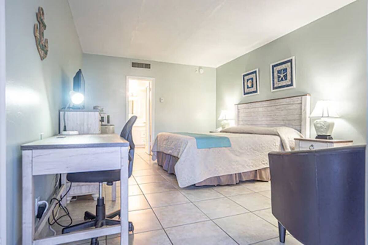 Une chambre à coucher avec un lit, un bureau et une chaise.