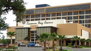 A modern building with a sign reading "Treasure Bay Casino".