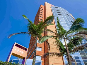 A hotel with a modern glass facade and a brick building adjacent to it. - Mercure Sao Paulo Jardins (São Paulo)