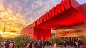A modern building with a prominent red facade and the word "METROPOLITAN" displayed.