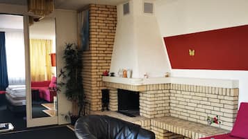 Deluxe Quadruple Room, 1 Bedroom, Balcony | Living area | TV, printers