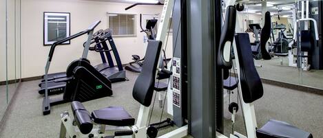 A gym with various exercise equipment, including treadmills and weight machines.