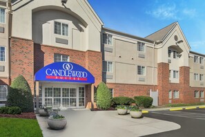 A hotel with a prominent 'Candlewood Suites' sign, a brick facade, and a parking lot with marked spaces. - Candlewood Suites Raleigh Crabtree by IHG (Raleigh)