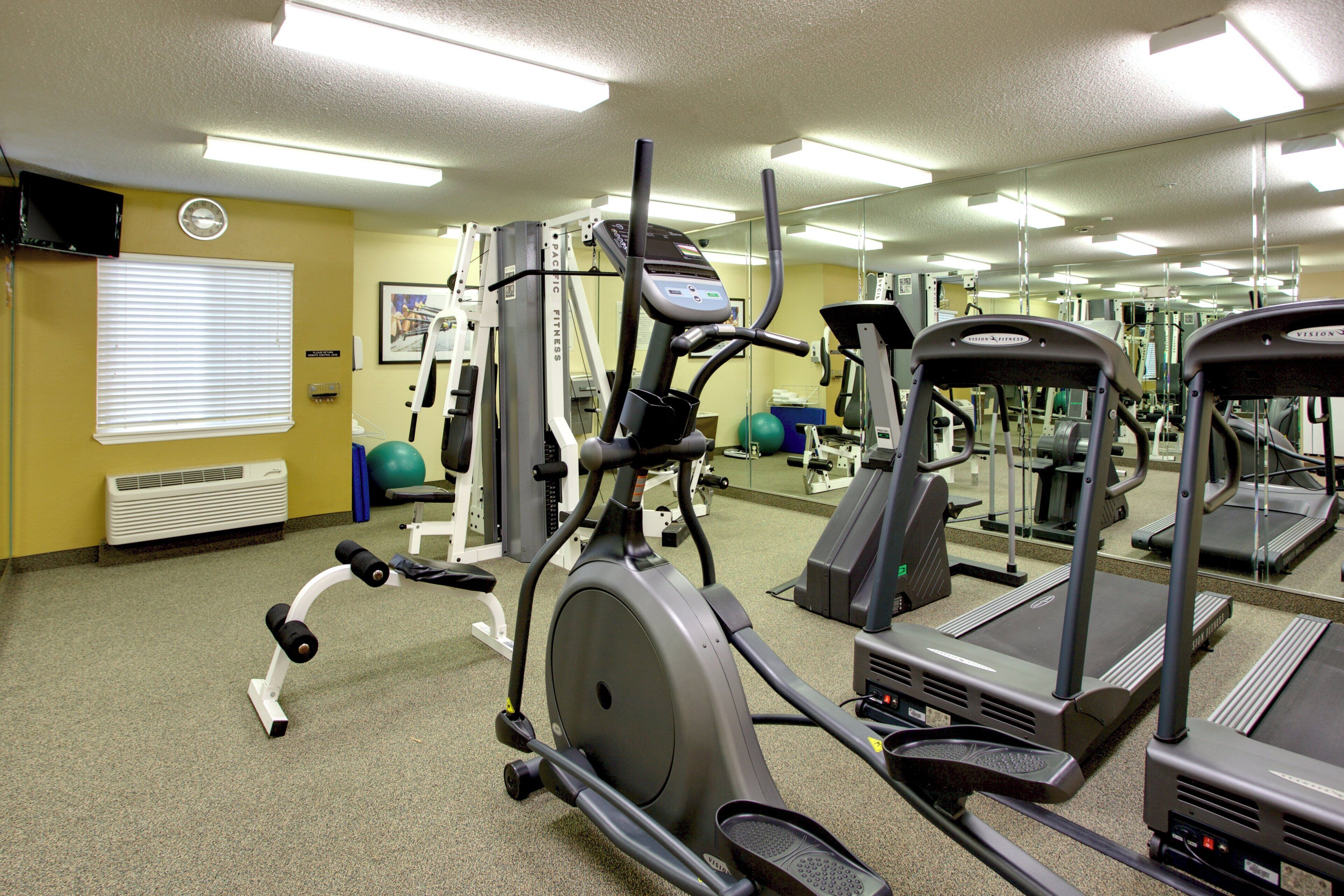 A gym with various exercise equipment, including treadmills and weight machines.