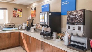A hotel breakfast area with a coffee machine, a juice dispenser, and a sign that says "Get your breakfast on." - Comfort Inn near Frost Bank Center (San Antonio)