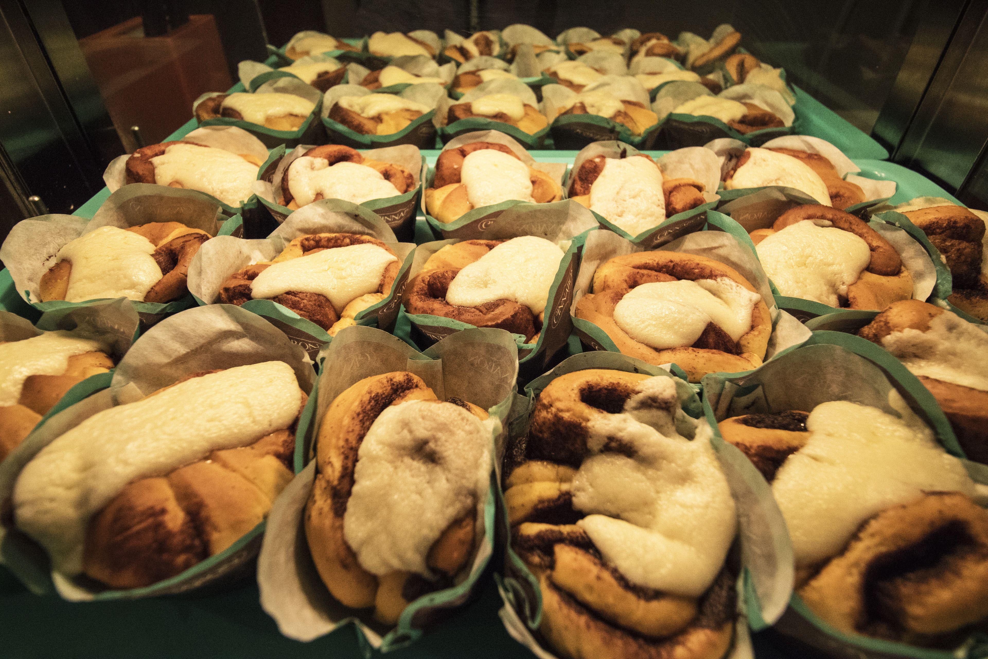 A display of various pastries in paper trays.