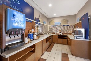 A self-service breakfast area with a coffee machine, cereal, hot food, and bakery options. - Holiday Inn Express - Balloon Fiesta Park by IHG (Albuquerque)