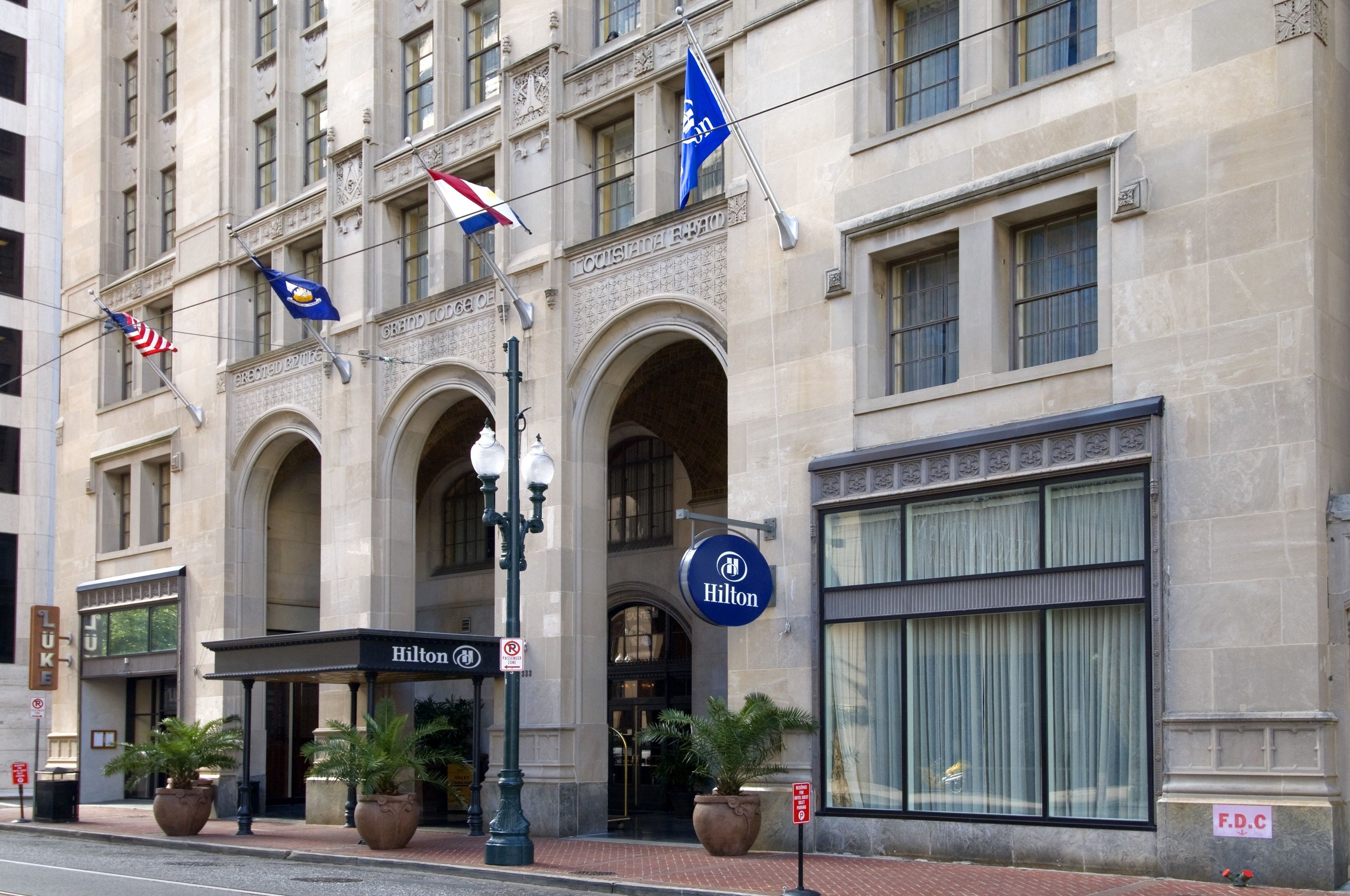 A hotel with a classic architectural style, featuring arched windows and a prominent entrance.