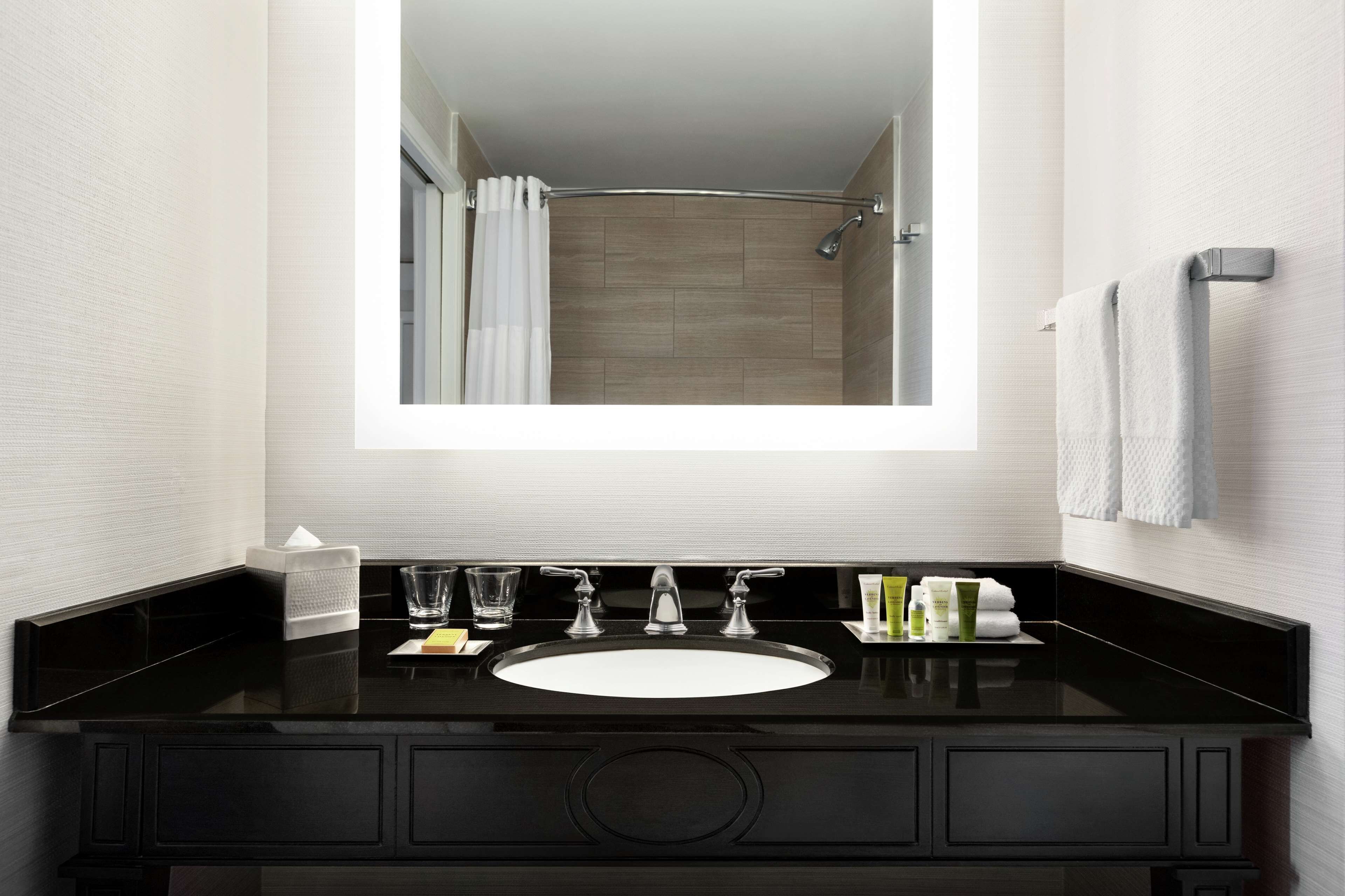 combined shower/bathtub, designer toiletries, hair dryer, towels