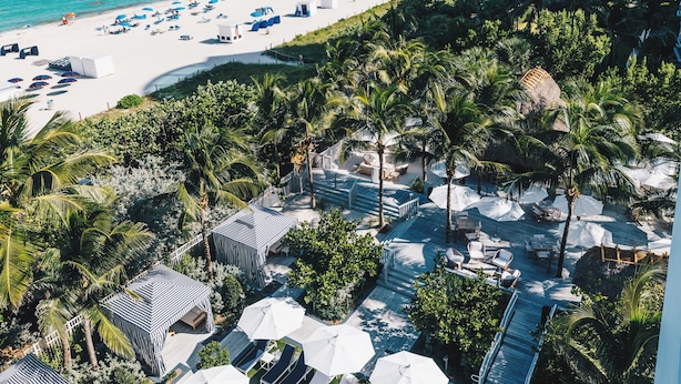 A resort with a pool, beach, and palm trees. - Cadillac Hotel & Beach Club, Autograph Collection (Miami Beach)
