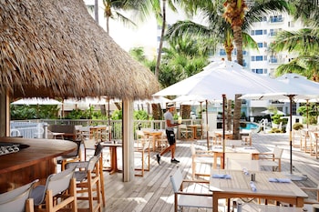 On the beach, sun loungers, beach umbrellas, beach towels at Cadillac Hotel & Beach Club, Autograph Collection