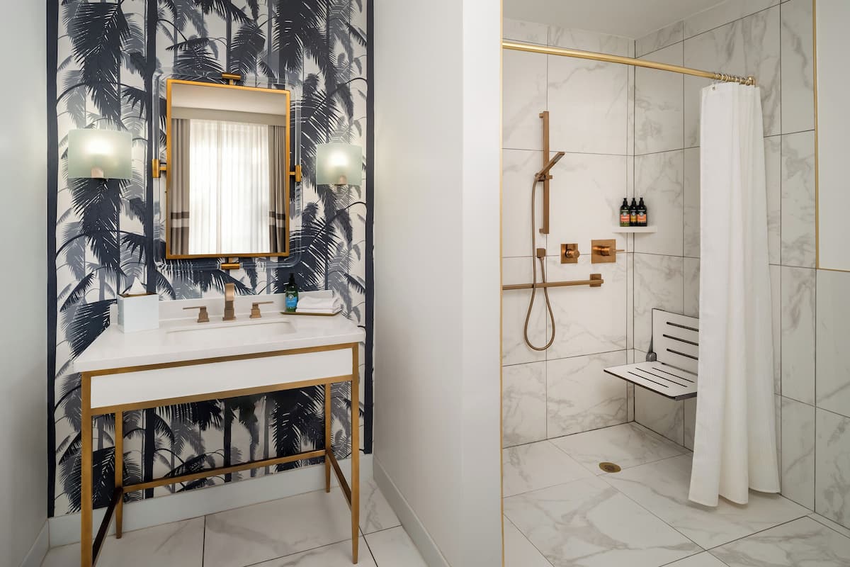 combined shower/bathtub, designer toiletries, hair dryer, towels