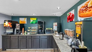 A self-service breakfast area with a coffee machine, microwave, and waffle maker. - Quality Inn Richland - Jackson South (Richland)