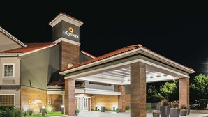 A hotel with a prominent 'La Quinta' sign, a covered entrance, and a well-lit facade. - La Quinta Inn & Suites by Wyndham Fort Worth North (Fort Worth)