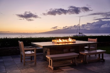 A multi-story hotel with a pool, garden, and ocean view. at Aston at The Whaler on Kaanapali Beach