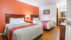 A hotel room with two beds, a desk, and a mirror. - Northway Inn Queensbury - Lake George (Queensbury)