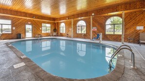 A large indoor swimming pool with wooden walls and arched windows. - Quality Inn Greenville North (Greenville)