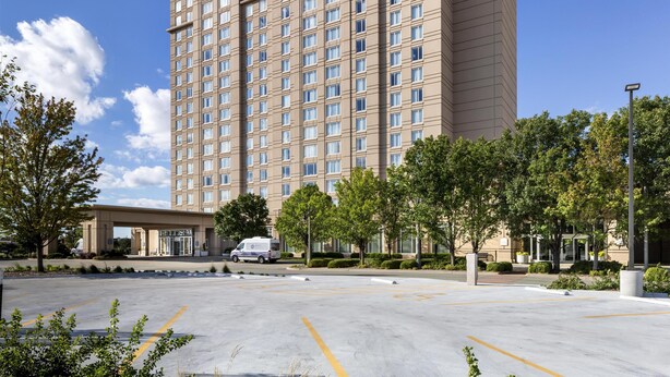 A multi-story hotel with a modern design, featuring a flat roof and a uniform facade.
