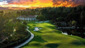 A golf course with a clubhouse, water hazards, and a forested area. - Park Hyatt Aviara Resort, Golf Club & Spa (Carlsbad)