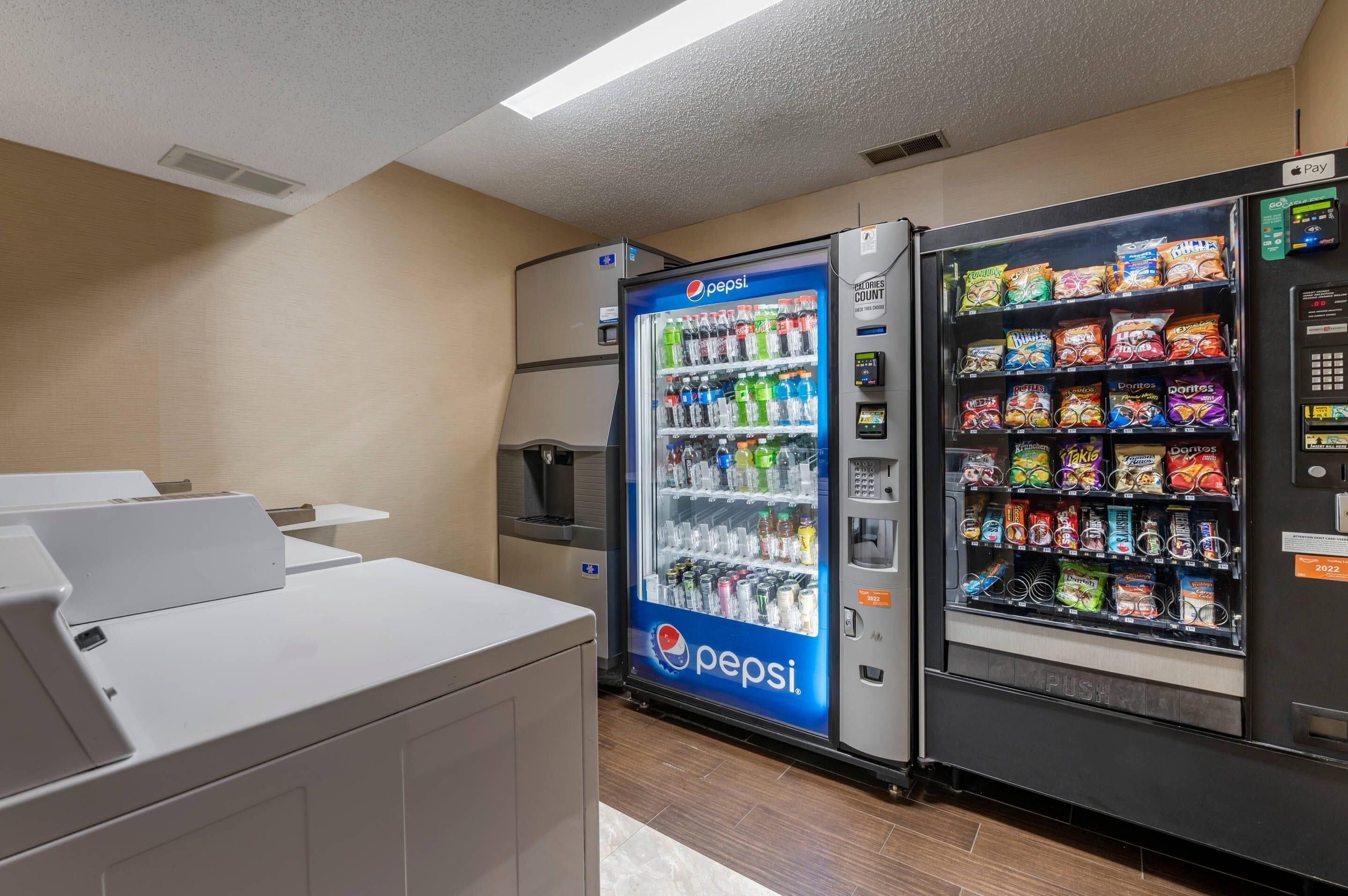 A vending area with Pepsi and Doritos machines, a trash bin, and a white counter.