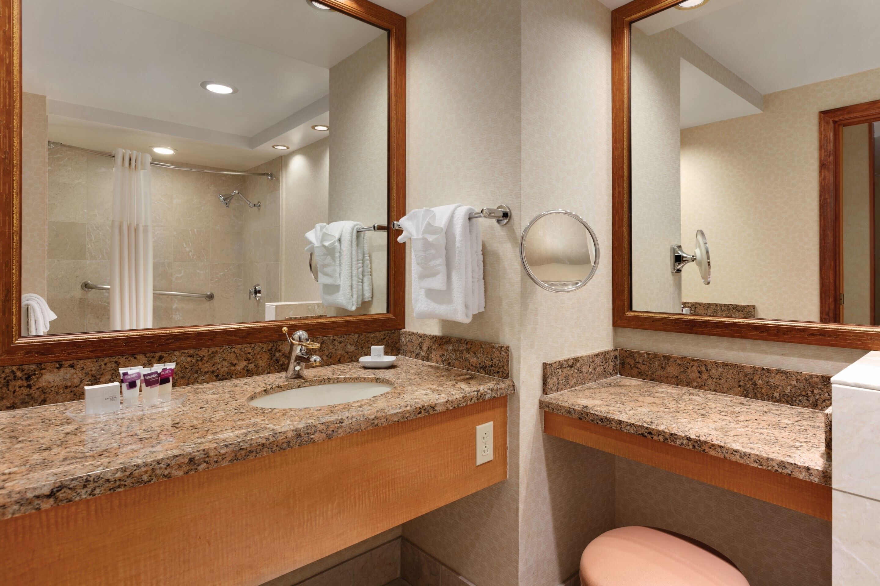 A bathroom with two sinks, a toilet, and a shower.