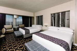 A hotel room with two beds, a sofa, a chair, and a patterned carpet. - Harrah's Lake Tahoe Hotel & Casino – A Caesars Rewards Destination (Stateline)