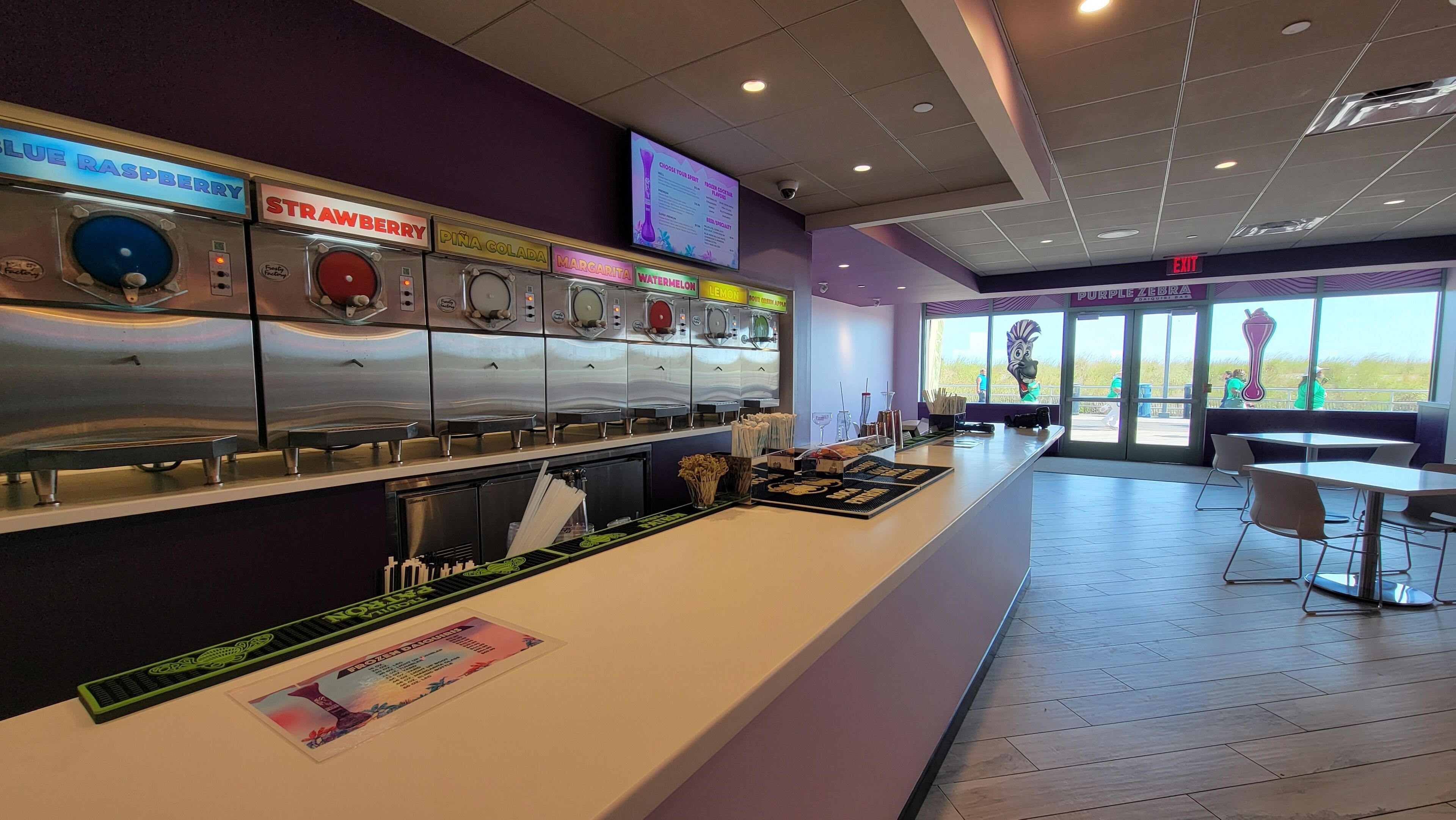 A food station with various drink dispensers and a menu board.