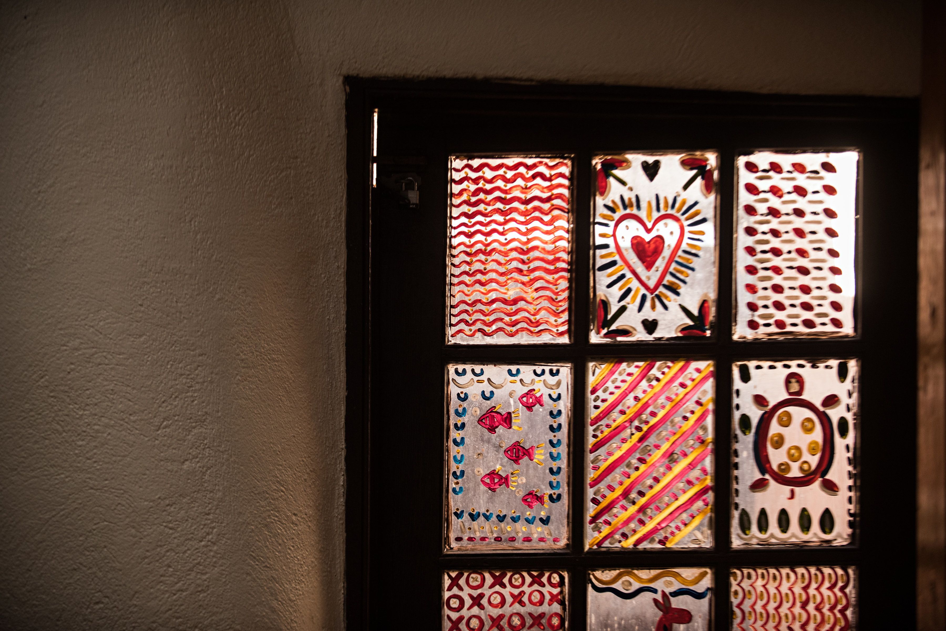 A door with multiple glass panels, each displaying different patterns and designs.