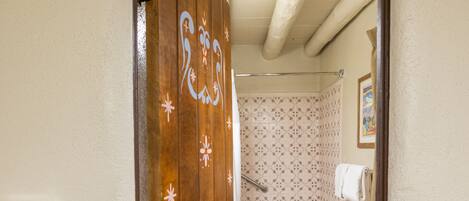 A bathroom with a toilet, bathtub, and shower.