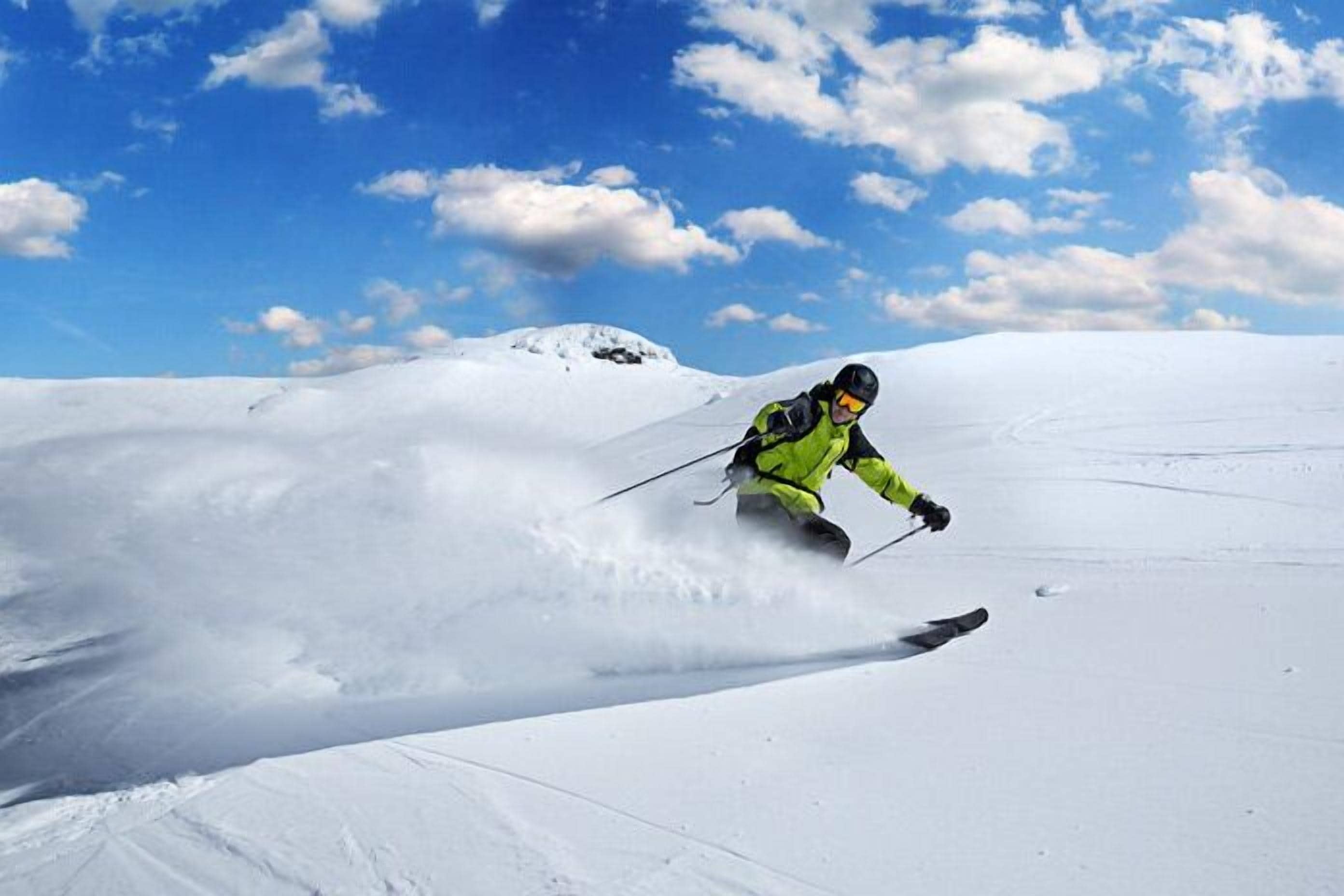 A person skiing on a snowy slope.