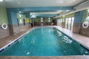 Una piscina techada, sillones reclinables de piscina