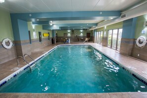 An indoor swimming pool with clear water, a diving board, and a lifeguard stand. - Holiday Inn Express Wilmington by IHG (Wilmington)