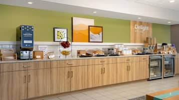 A modern kitchen with wooden cabinets, a coffee machine, and a refrigerator.