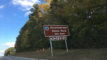 A road sign indicating Oconeechee State Park is next right.