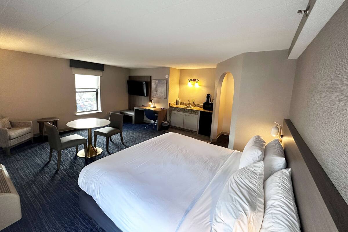 Desk, iron/ironing board, bed sheets
