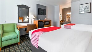 A hotel room with two beds, a desk, a chair, a television, and a microwave. - OYO Hotel Lake Park/Valdosta I-75, Exit 5 (Lake Park)