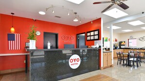 A reception desk with a sign reading "OYO HOTEL" and a clock above it. - OYO Hotel Lake Park/Valdosta I-75, Exit 5 (Lake Park)