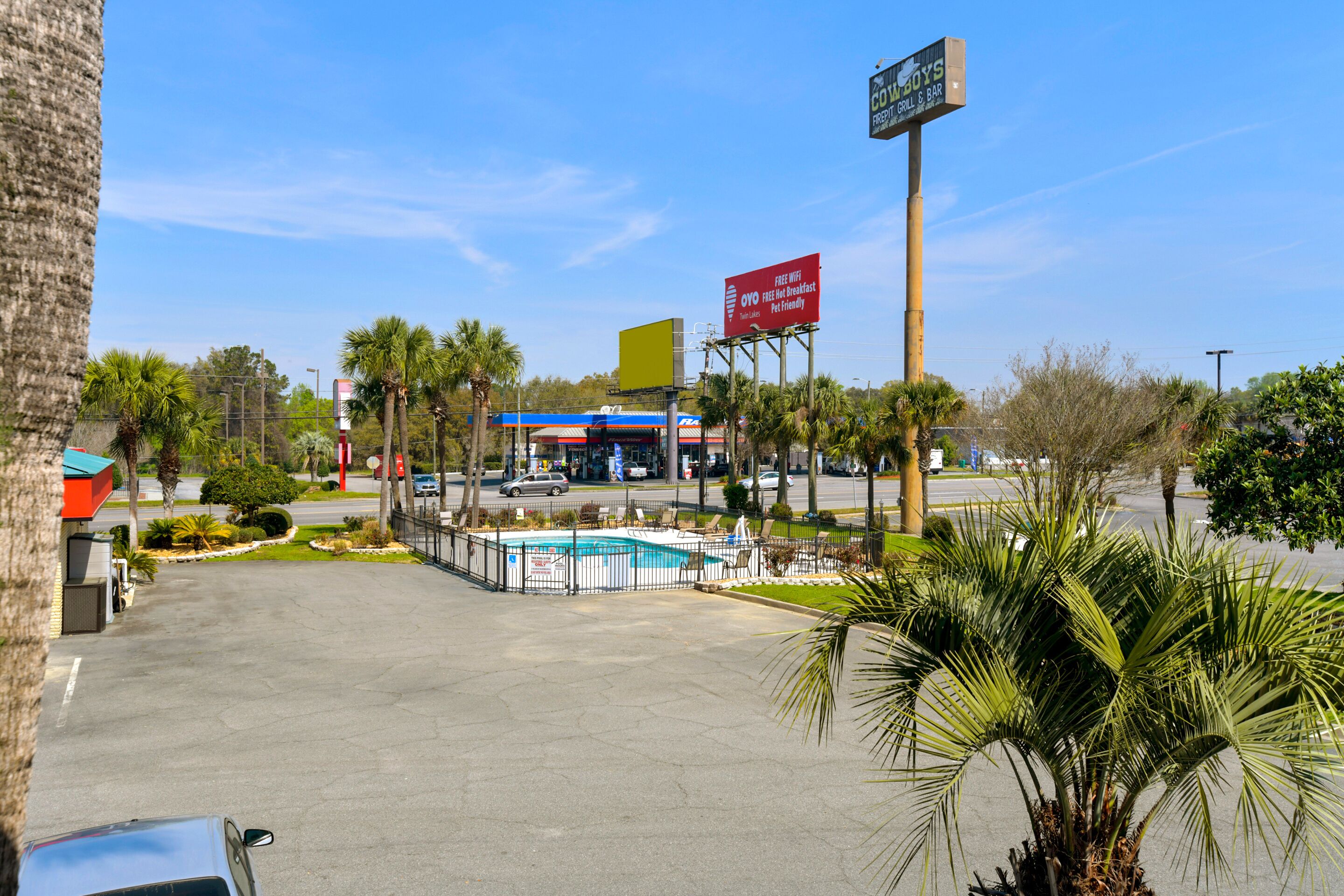 A commercial area with a pool, a restaurant, and a gas station.