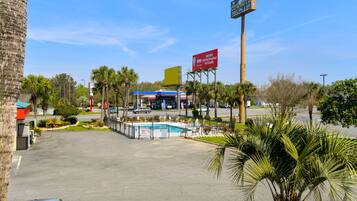 A commercial area with a pool, a restaurant, and a gas station.