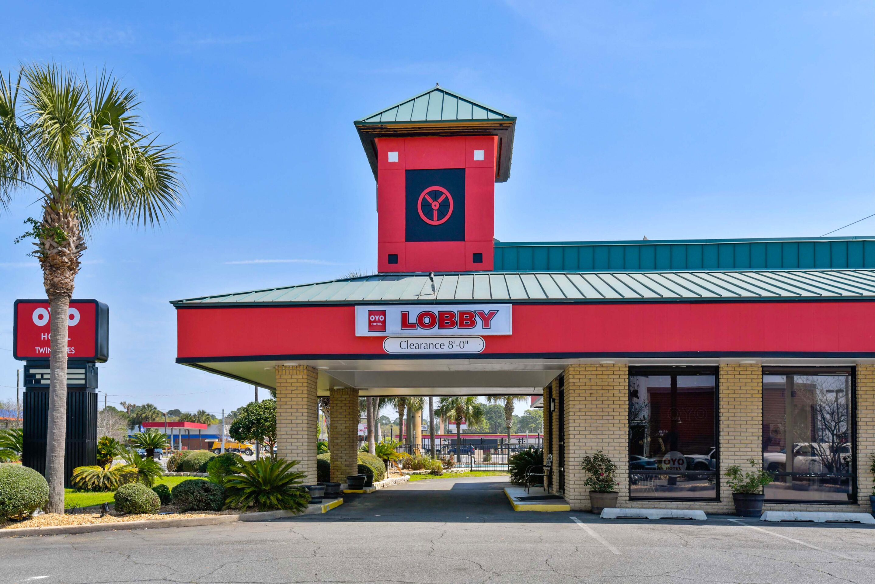 A red building with a sign reading "Lobby" and a clearance sign of 8'-0".