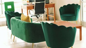 A modern office space with green upholstered chairs, a wooden desk, and a computer setup. - Quality Inn near Chattanooga South (Ringgold)