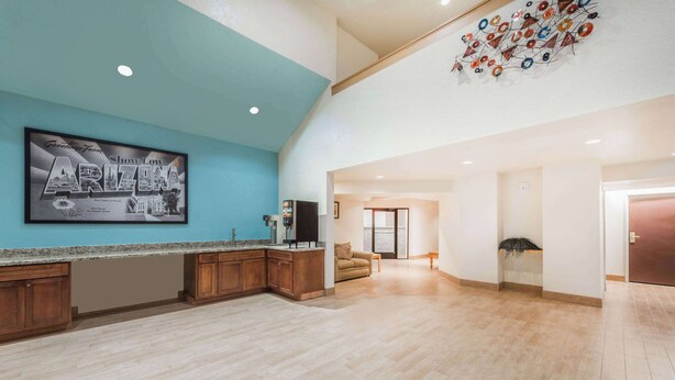 A spacious kitchen with a blue accent wall, a large framed Arizona sign, and a modern ceiling design. - Super 8 by Wyndham Show Low (Show Low)