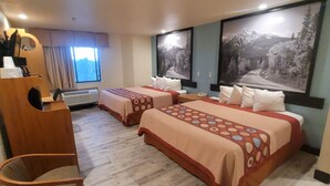 A hotel room with two beds, a wooden chair, a desk with a telephone, and a large window. - Super 8 by Wyndham Show Low (Show Low)