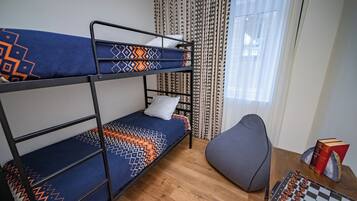 Cozy retreat with a bunk bed setup, seating area, and chessboard for relaxation.