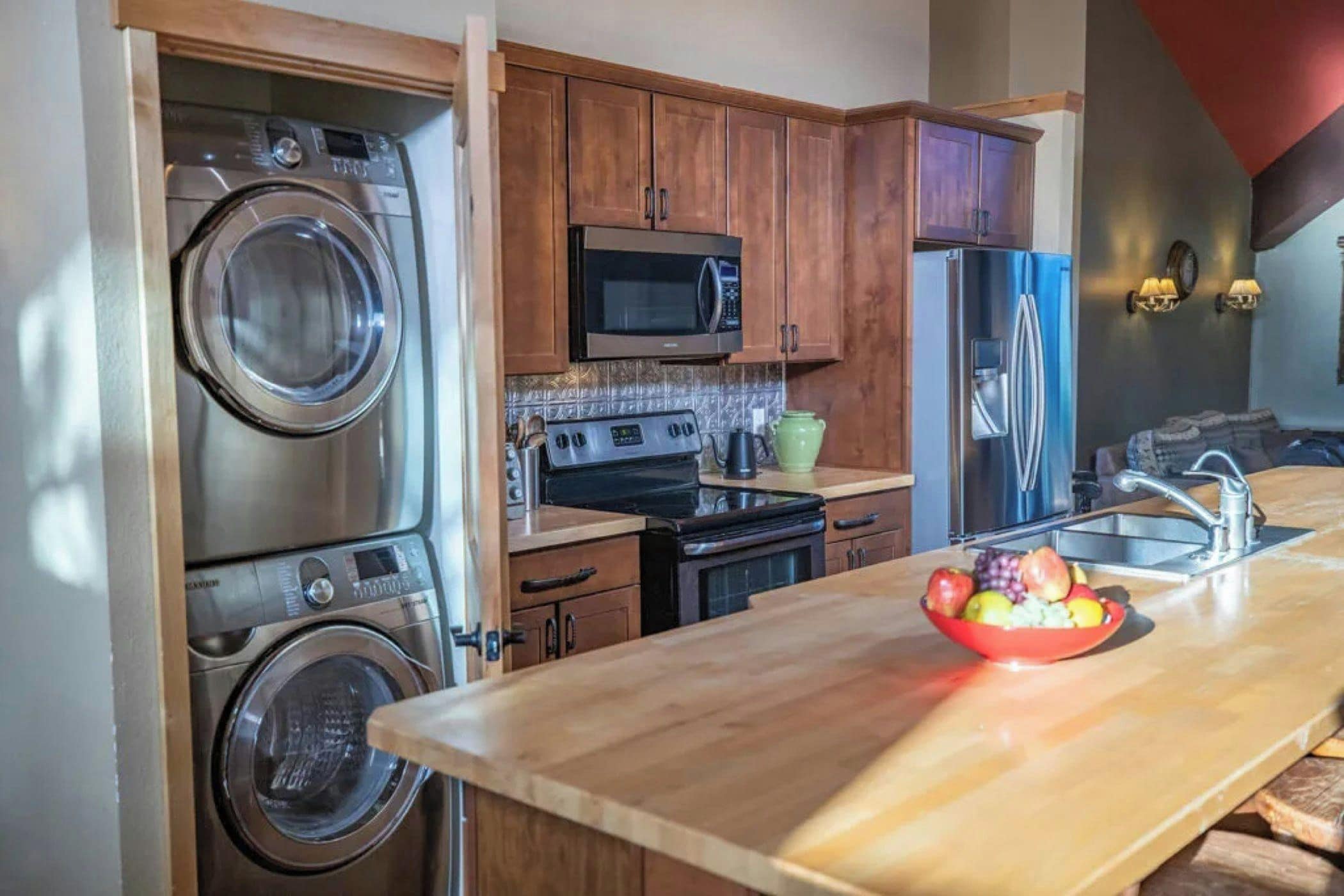 A kitchen with a built-in washer, microwave, oven, and refrigerator.