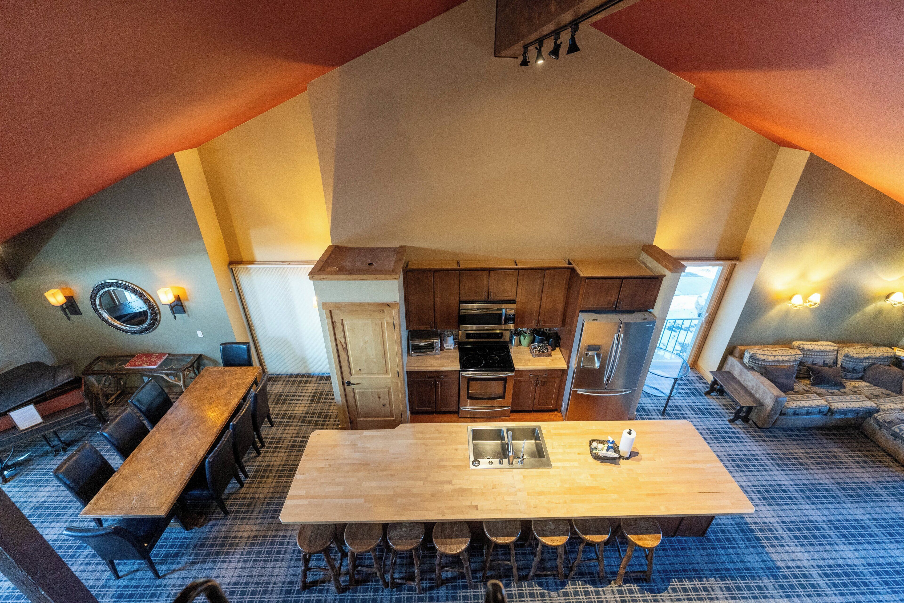 A spacious loft with a kitchen, dining area, and a cozy seating area.